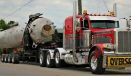 A Crane and Rigging Trailer Carries an Oversize Load