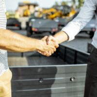 Closeup of a Trailer Salesman Shaking Hands With a Customer What Is Pinnacle Trailer’s Hold It for Me Program