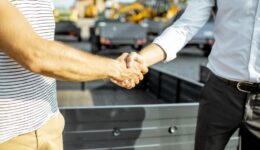 Closeup of a Trailer Salesman Shaking Hands With a Customer What Is Pinnacle Trailer’s Hold It for Me Program