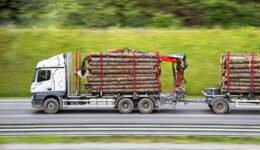 A logging trailer moving down the highway and what type of logging trailer is right for you